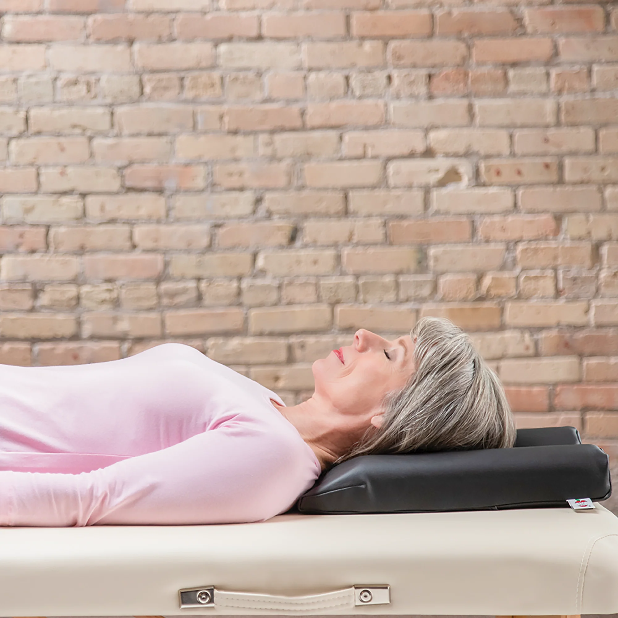 Image of client on her back lying face-up on the Core Products Max Relax face rest cushion
